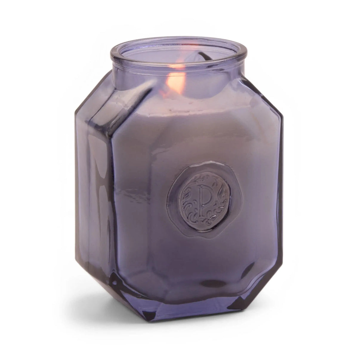 The Sea Salt + Amber Botanica 8 oz Candle glows in a faceted, translucent purple jar with an embossed emblem, perfect for enhancing your home fragrance experience.