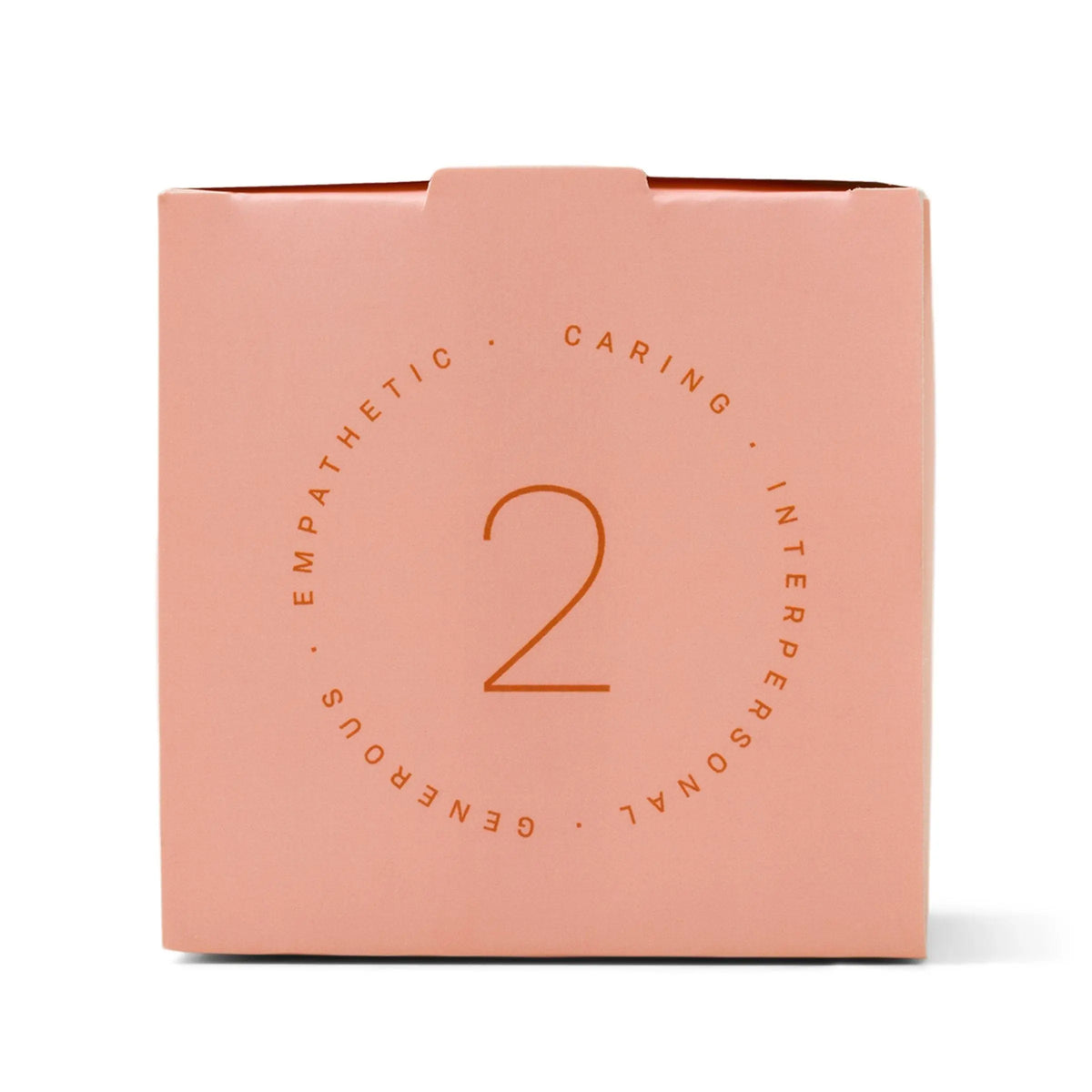 A pink box featuring the number 2 at its center, encircled by the words “CARING,” “INTERPERSONAL,” “GENEROUS,” and “EMPATHETIC” in a circular design—perfect for gifting as the Enneagram #2 Helper 5 oz Candle in Violet + Vanilla fragrance.