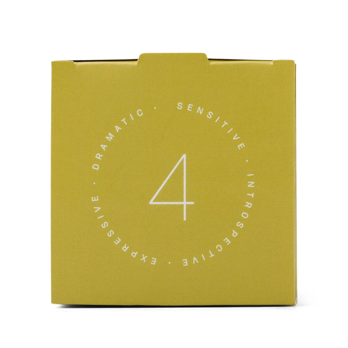 A yellow square box featuring a bold white number 4 at its center is encircled by the words "Dramatic, Sensitive, Introspective, Expressive." The Enneagram #4 Individualist 5 oz Candle in Prickly Pear draws inspiration from Enneagram candles, making it an ideal fragrance gift set that celebrates individuality and thoughtful design.