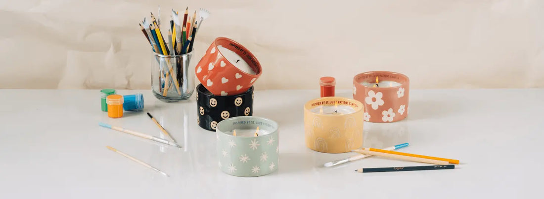 St. Jude candles with artistic supplies around them