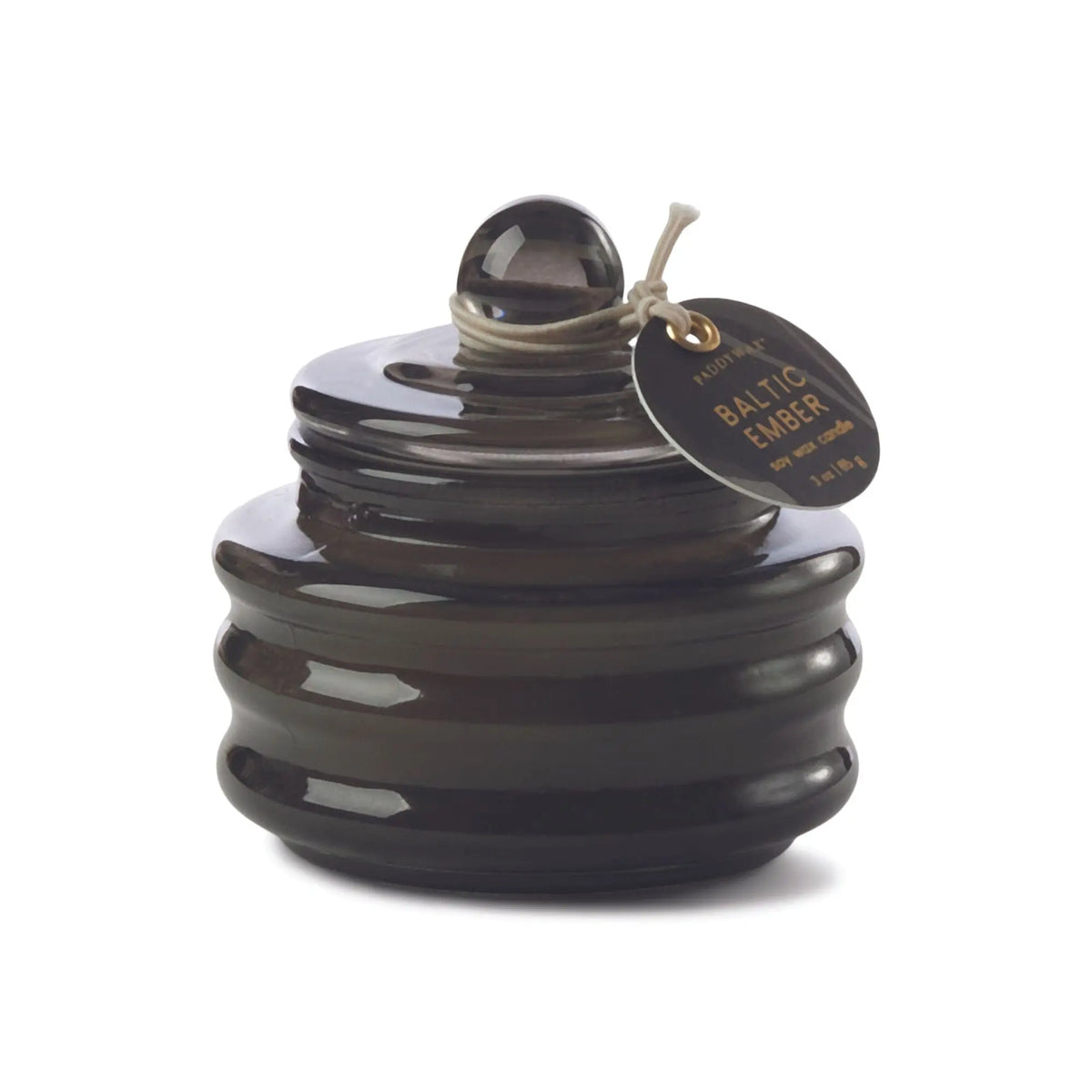 The Baltic Ember - Beam 3 oz Candle features a dark brown ribbed glass jar with a round lid and tag, ideal for adding ambient light and luxury fragrance to any space.