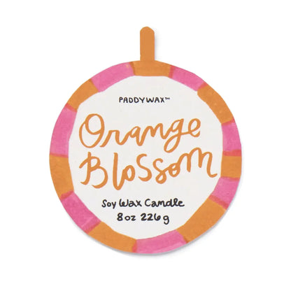 Round label with pink and orange border reads Orange Blossom - A Dopo 8 oz Candle in handwritten-style text, evoking a Mediterranean fragrance often associated with ceramic candles.