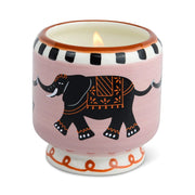 A Dopo's 8 oz Tobacco & Vanilla candle, hand-painted and set in a pink ceramic holder featuring a black elephant design, black-and-white rim, and orange patterns around the base.