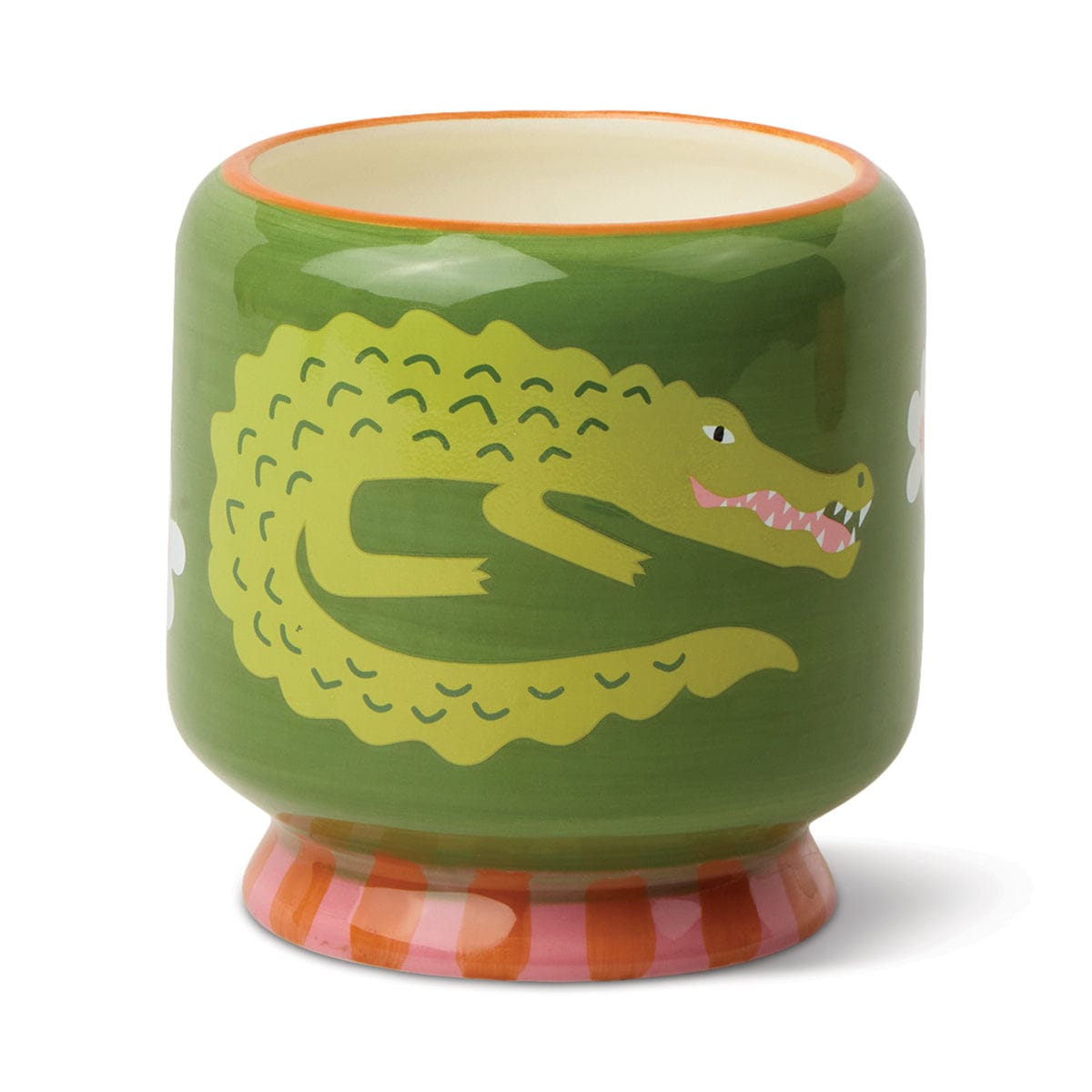 A green ceramic cup with a painted crocodile and pink striped base, perfect for holding the Prickly Pear - A Dopo 8 oz Candle and enjoying its bold fragrance.