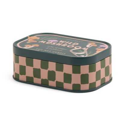 The Wild Mushroom - Bistro 4.5 oz Tin Candle features a soy wax scent in a rectangular tin with green and pink checkerboard sides and an illustrated lid with mushrooms, leaves, and the "Wild Mushroom" label.