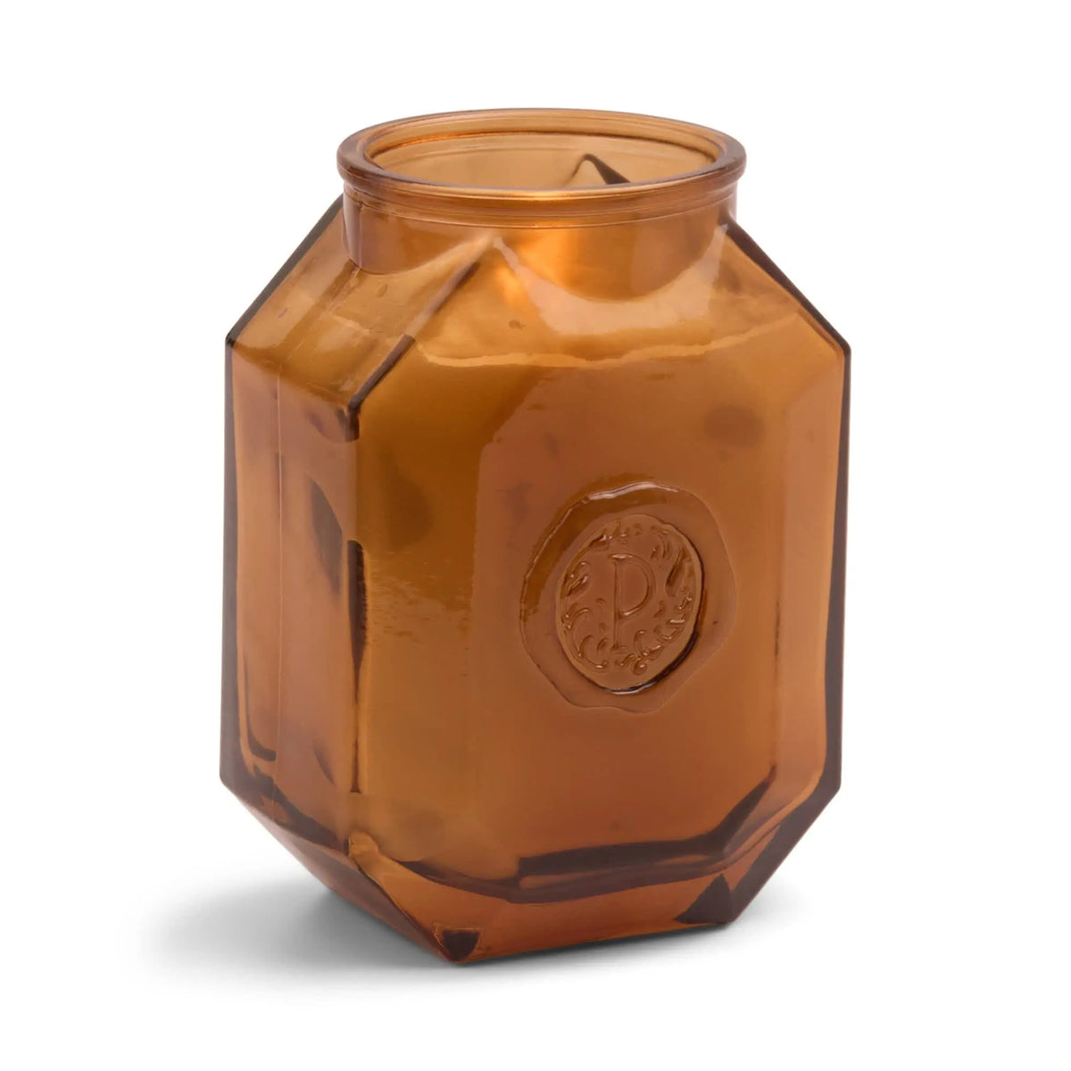 The Leather + Smoke - Botanica 8 oz Candle features an elegant brown, hexagonal glass jar with a raised circular emblem—perfect for adding sophistication to any space.