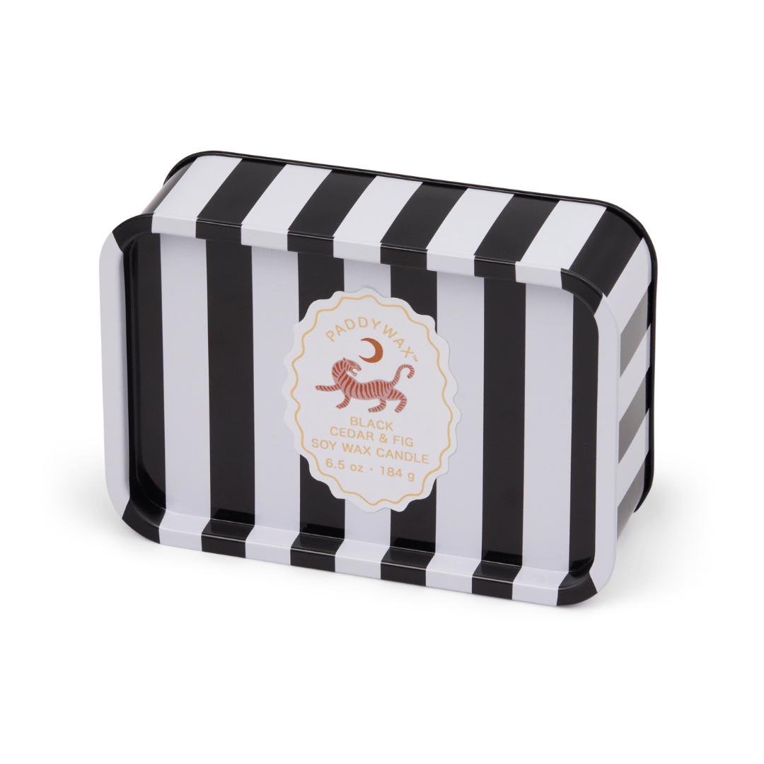 The Black Cedar & Fig - A Dopo 6.5 oz Tin Candle features bold black and white stripes and a round center label—this Mediterranean-inspired soy wax candle is perfect for travel or any adventure.