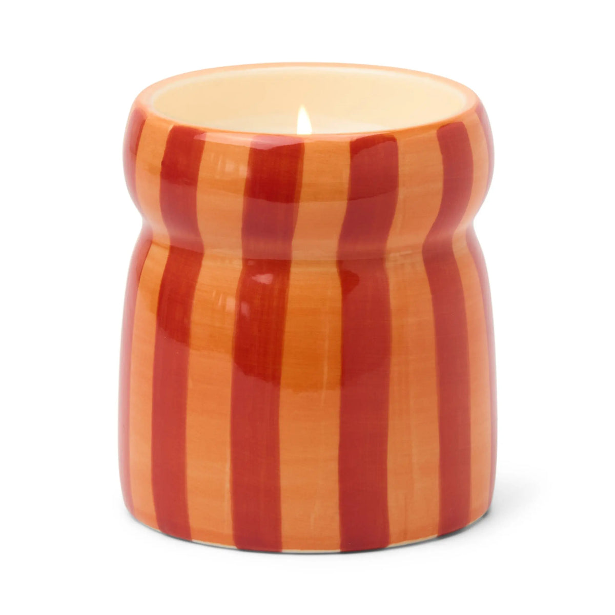 The Spiced Apple - Cabana 6.5 oz Candle burns gently in a ceramic holder featuring glossy orange and red vertical stripes, set against a plain white background—making it the perfect cheerful holiday accent.