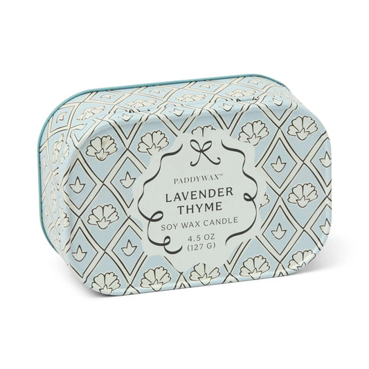 A decorative tin candle labeled Lavender & Thyme - Chérie 4.5 oz Tin Candle, featuring a blue and white floral pattern—perfect for adding the soothing aroma of lavender and thyme to any space.