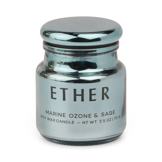 A metallic blue jar candle from the Chroma Collection, labeled Sea Salt & Sage - Chroma 2.5 oz Candle, features electroplated glass with a reflective finish and a rounded lid.