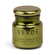 A metallic green, electroplated glass jar labeled Pacific Moss & Mist - Chroma 2.5 oz Candle. The jar features a rounded lid and a simple, modern design, reflecting the sophisticated style of Chroma candles and their Latin-inspired fragrance collection.