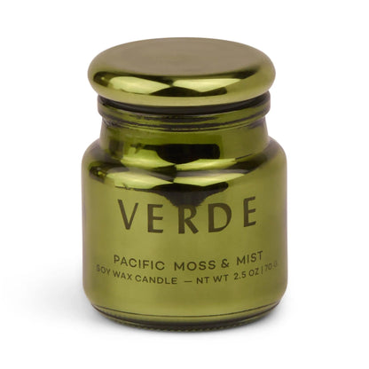 A metallic green, electroplated glass jar labeled Pacific Moss & Mist - Chroma 2.5 oz Candle. The jar features a rounded lid and a simple, modern design, reflecting the sophisticated style of Chroma candles and their Latin-inspired fragrance collection.
