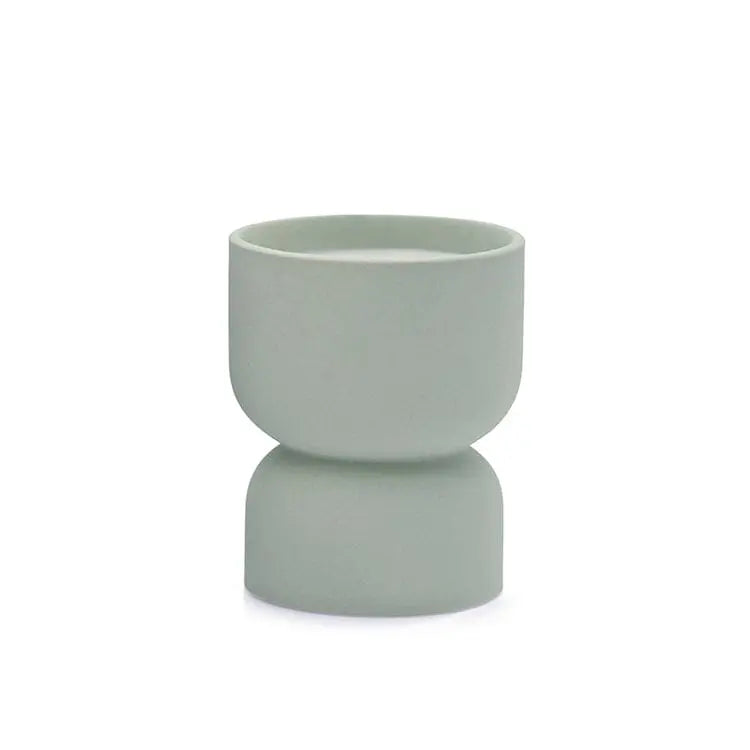 The Ocean Rose & Bay - Form 6 oz Candle features a minimalist, light gray-green ceramic cup with a rounded top and subtly wider base, ideal for home decor. Shown against a white background.