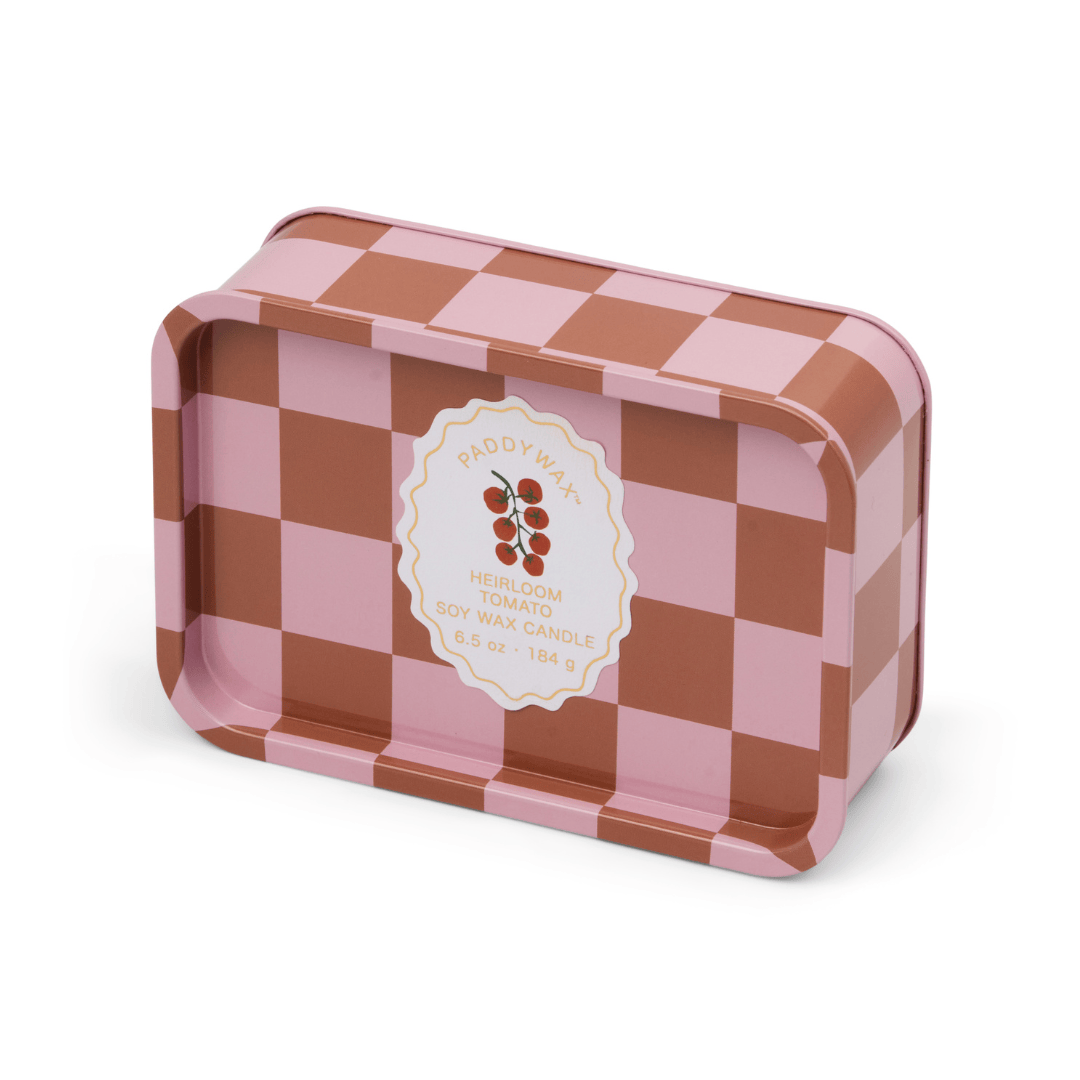A rectangular reusable tin candle with a pink and brown checkerboard pattern, labeled Heirloom Tomato - A Dopo 6.5 oz Tin Candle—perfect for adding a Mediterranean garden vibe to your space.