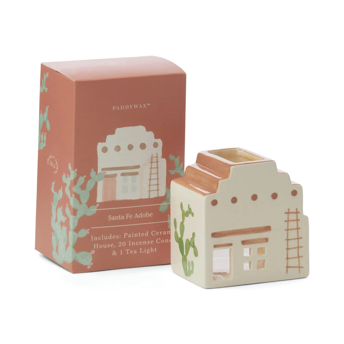 No. 03 The Santa Fe Adobe - Incense & Tea Light Holder is a painted ceramic adobe house, paired with a terracotta-toned box featuring cactus illustrations and Santa Fe Adobe text with listed contents. Perfect for adobe decor.