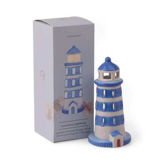 No. 07 The Lighthouse - Incense & Tea Light Holder is a blue and white ceramic coastal lighthouse, packaged in a box labeled "Connecticut Lighthouse" with an illustrated likeness of the piece. The set includes incense cones and a tea light, making it a charming décor accent as well as a functional incense and tealight holder for burning your favorite scents such as palo santo.