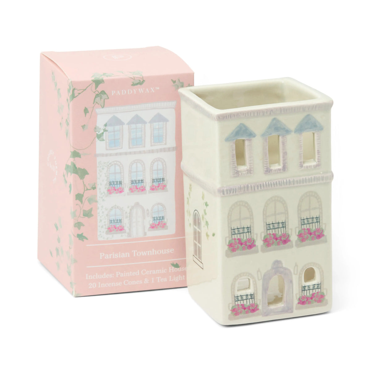 A painted ceramic holder shaped like a Parisian townhouse sits beside its pink floral box labeled No. 09 The Parisian Townhouse - Incense & Tea Light Holder. The packaging indicates it includes incense cones, such as Palo Santo, and a tea light—making this charming piece a delightful collectible incense holder for your home.