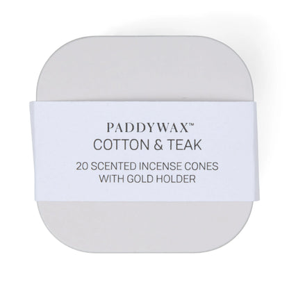 The Cotton & Teak - Metal Incense Tin contains 20 top-selling scented incense cones and includes a gold incense cone holder. The rounded tin features a white paper band with black text.