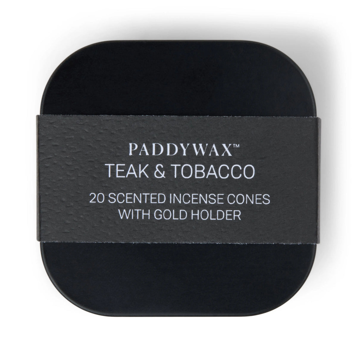 A black tin labeled “Teak & Tobacco - Metal Incense Tin” is shown from above, wrapped with a textured paper band. This set features one of Paddywax’s best-selling fragrances and includes a gold holder for effortless incense enjoyment.