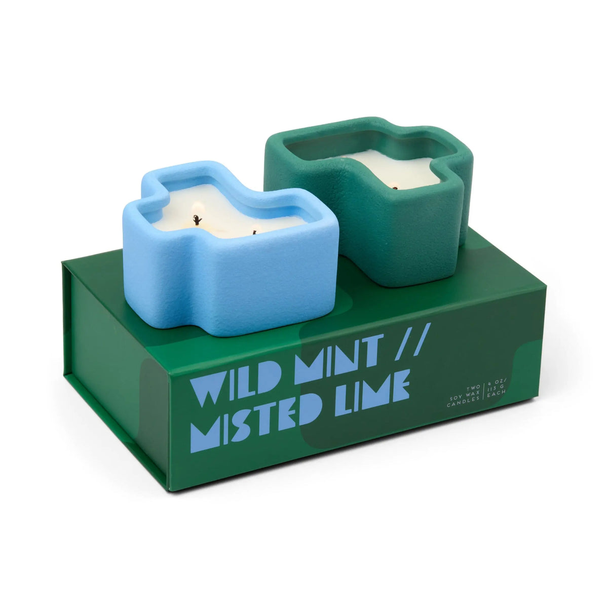 The Wild Mint & Misted Lime - Jigsaw 4 oz Candle Boxed Set features two candles in blue and green Texas-shaped ceramic holders, beautifully presented on a matching green box—an ideal home accessory with a charming touch.