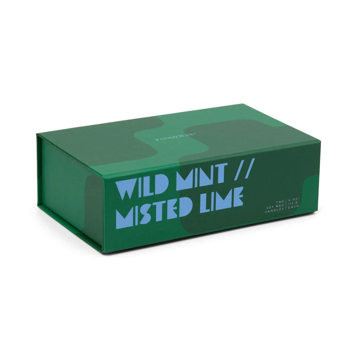 A green rectangular box featuring abstract shapes and bold blue text reading "WILD MINT // MISTED LIME" on the side, designed for the Wild Mint & Misted Lime - Jigsaw 4 oz Candle Boxed Set, suggesting a refreshing and thoughtfully curated ceramic candle pairing inside.