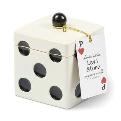 A square, white ceramic Lava Stone - Lucky Dice 10 oz Candle shaped like a die with black dots, featuring a black sphere on the lid and a hanging tag shaped like a playing card.