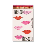 A hand-painted box of Bisou Bisou - Large Rectangle Boxed Matches features pink and red lips with BISOU and allumettes—an adorable Valentine’s gift. The open box shows off the colorful match tips.
