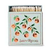 The Oranges - Square Boxed Matches feature a hand-painted light blue cover with an orange branch of nine oranges and green leaves, plus Safety Matches printed at the bottom.