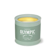 The Olympic - Parks 6 oz Tin Candle features a green tin, Olympic National Park label, Pacific Moss + Mist scent, and off-white wax—a perfect gift for outdoor lovers and fans of national parks.