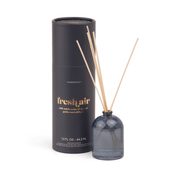 A dark blue Fresh Air - 1.5 oz Diffuser in a milky glass bottle with wooden reeds sits next to a matching cylindrical box, labeled "fresh air" in gold, which describes the scent and makes an elegant fragrance gift.