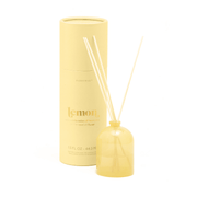 A Lemon - 1.5 oz Diffuser in milky yellow glass with a lemon scent and three wooden reeds stands by its matching cylindrical packaging, labeled "lemon" in light yellow and featuring the Paddywax brand for a refreshing fragrance.