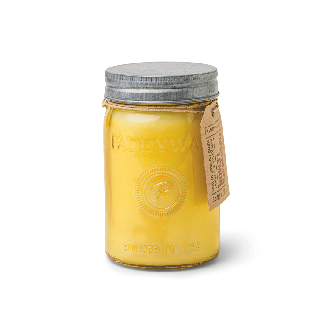The Fresh Meyer Lemon - Relish 9.5 oz Candle features a yellow wax in a glass mason jar with metal lid and brown paper tag, labeled "Paddywax" and "Poured in USA," and is filled with a delightful fragrance.