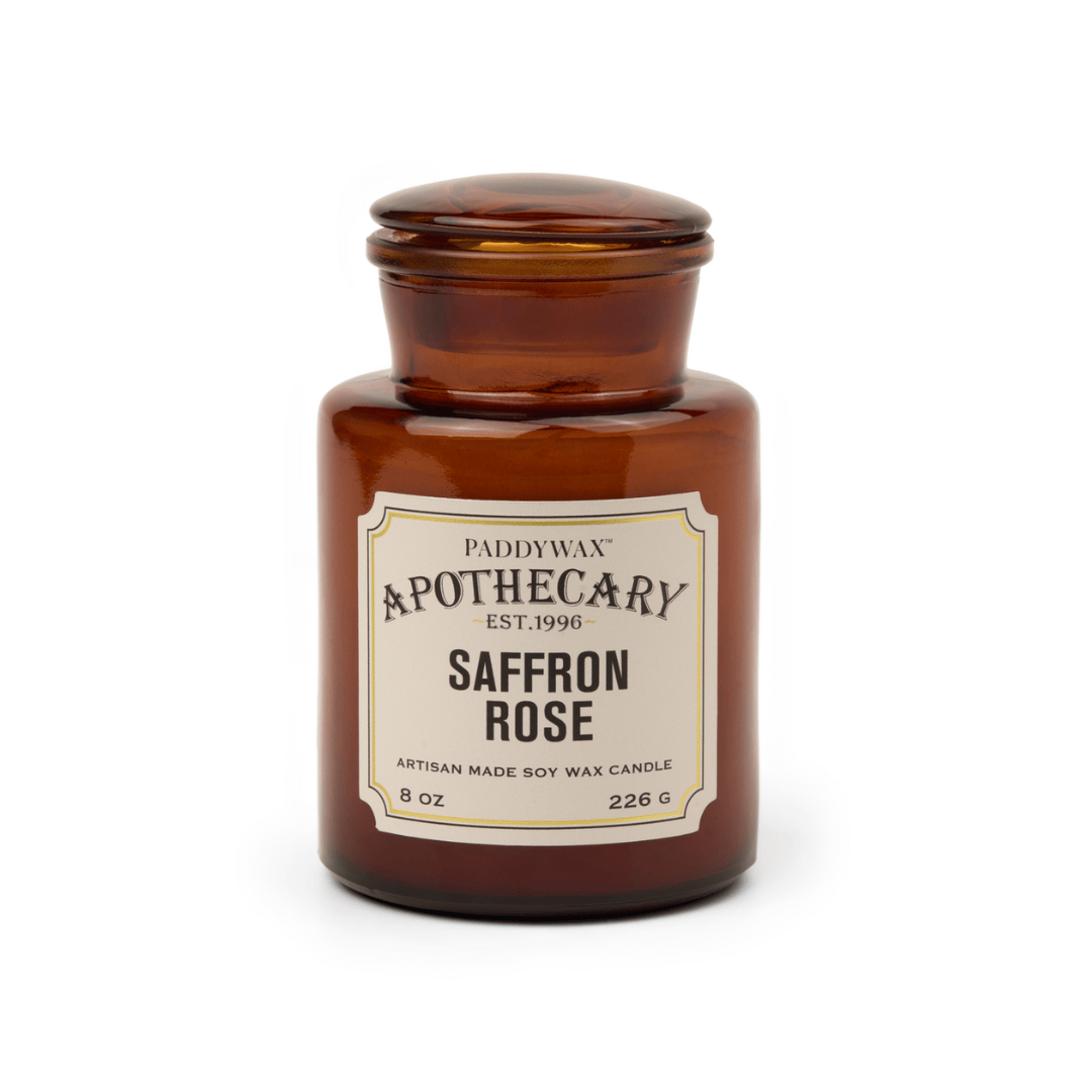 An 8 oz artisan candle named Saffron + Rose - Apothecary, made of soy wax in a brown glass vessel with a vintage apothecary-style label and lid.