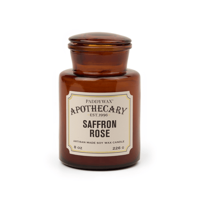 An 8 oz artisan candle named Saffron + Rose - Apothecary, made of soy wax in a brown glass vessel with a vintage apothecary-style label and lid.