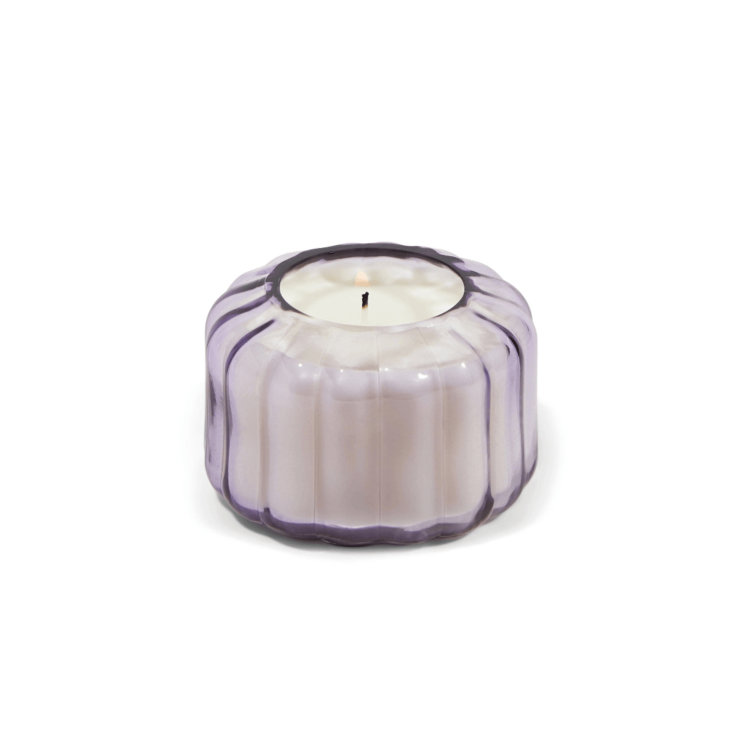 The Salted Iris - Ripple 4.5 oz Candle features a vintage-style, round, ribbed glass holder with a light purple tint, shown from the front against a white background.