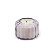 The Salted Iris - Ripple 4.5 oz Candle features a vintage-style, round, ribbed glass holder with a light purple tint, shown from the front against a white background.