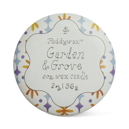 Garden & Grove - Tulip 2 oz Tin Candle in a round tin with a floral-patterned lid, whimsical script, and pastel purple, blue, yellow, and orange accents. Soy wax candle weighs 2 oz (56 g).