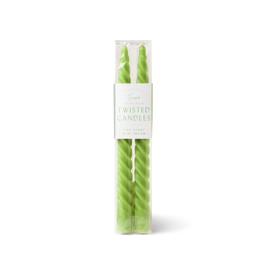 A clear box holds two tall, light green twisted taper candles with cotton wicks and a white label reading "Green Twisted Taper Candles, Two Count, 10 in | 25.4 cm.