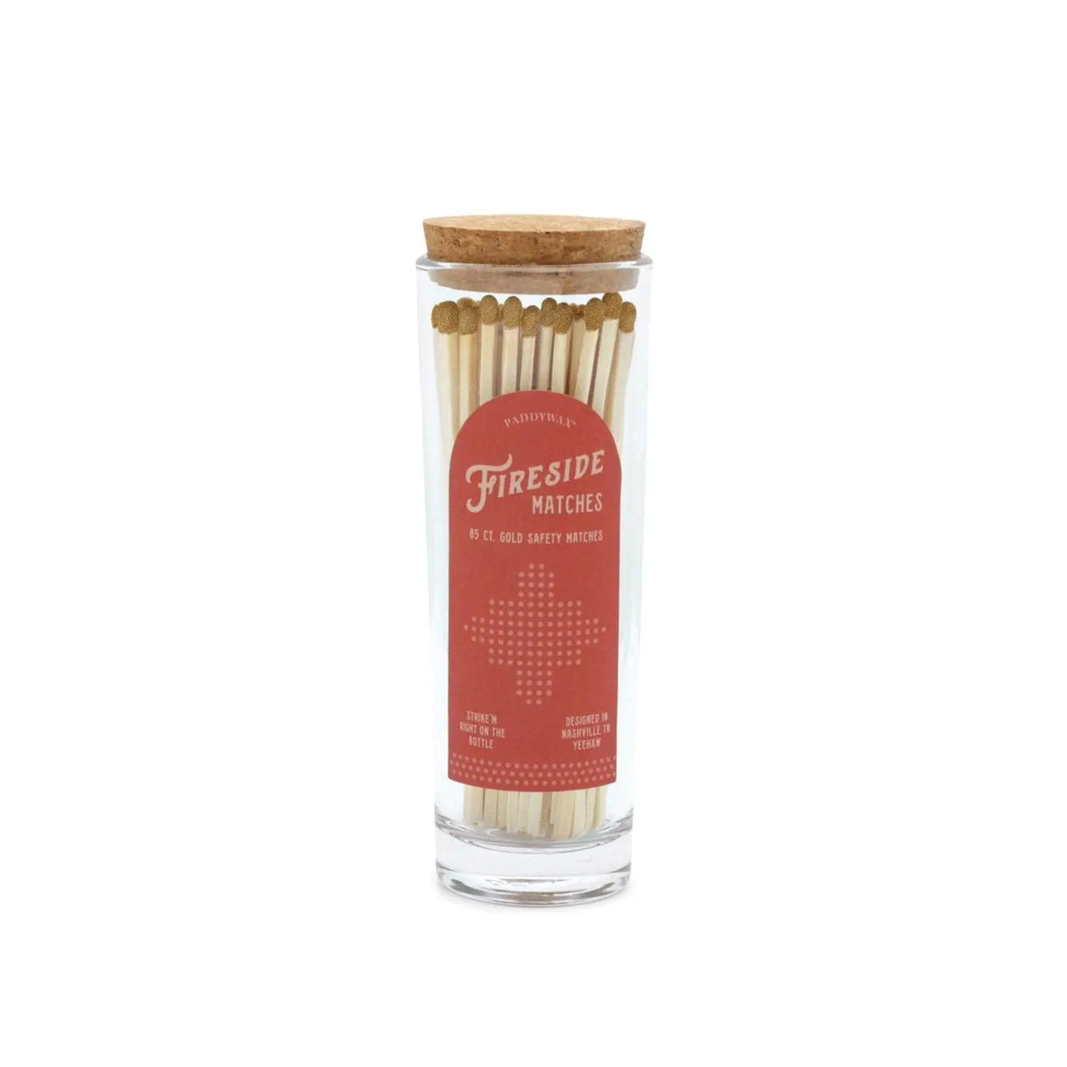 A glass jar with a cork lid filled with safety matches, labeled "Fireside Safety Matches - Gold" in white text on a red background, features white-tipped matches arranged upright—making it the perfect companion for lighting candles in your home.