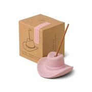 The Hinoki Wood - Incense Holder is a pink ceramic cowboy hat designed to hold incense sticks. It comes with a brown packaging box—perfect for enjoying your favorite scents.