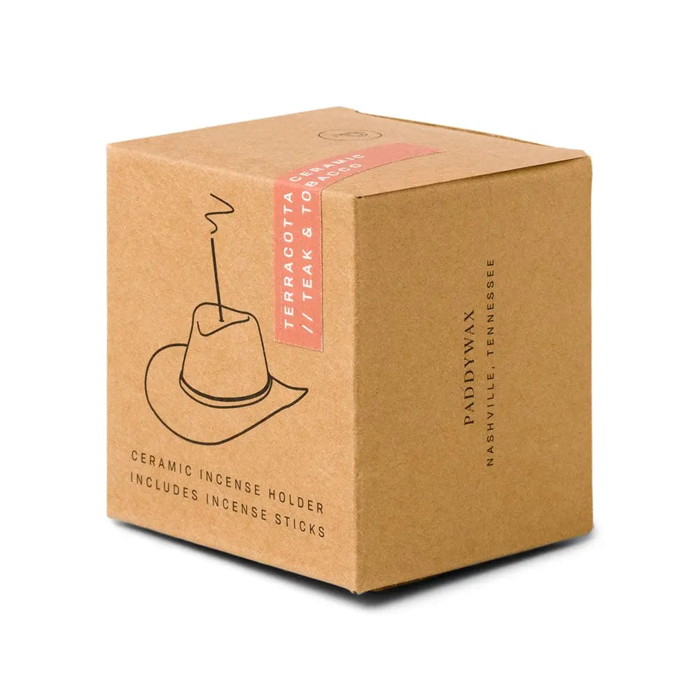 A brown cardboard box labeled “Teak & Tobacco - Incense Holder” features minimalist line art of a cowboy hat incense holder and product details on the sides. Includes incense sticks—perfect as a Nashville gift set.