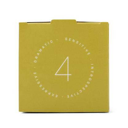A yellow square box featuring a bold white number 4 at its center is encircled by the words "Dramatic, Sensitive, Introspective, Expressive." The Enneagram #4 Individualist 5 oz Candle in Prickly Pear draws inspiration from Enneagram candles, making it an ideal fragrance gift set that celebrates individuality and thoughtful design.