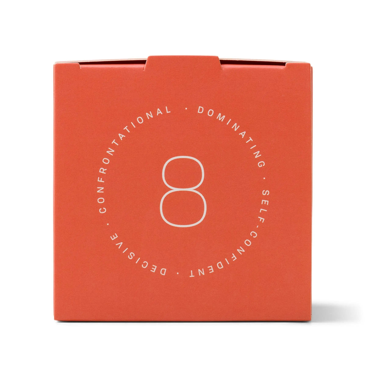 A striking red box featuring a bold white number 8 at its center, encircled by the words "CONFRONTATIONAL, DOMINATING, SELF-CONFIDENT, DECISIVE," perfectly embodies the Enneagram #8 Challenger 5 oz Candle - Incense + Smoke. This candle’s vibrant ombre glass design and distinctive fragrance are crafted to reflect the powerful spirit of your personality type.