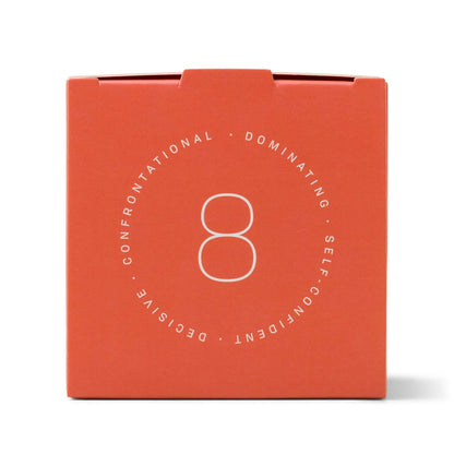 A striking red box featuring a bold white number 8 at its center, encircled by the words "CONFRONTATIONAL, DOMINATING, SELF-CONFIDENT, DECISIVE," perfectly embodies the Enneagram #8 Challenger 5 oz Candle - Incense + Smoke. This candle’s vibrant ombre glass design and distinctive fragrance are crafted to reflect the powerful spirit of your personality type.