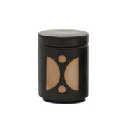 The Palo Santo Suede - Form 12 oz Candle is a black cylindrical ceramic container with a fitted lid, decorated with geometric tan shapes and dots on the front.