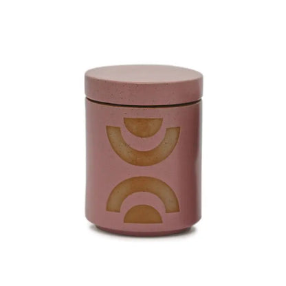 The Mandarin Mango - Form 12 oz Candle comes in a pink ceramic container with a lid and two tan semicircle designs—ideal for home decor or as a chic planter candle.