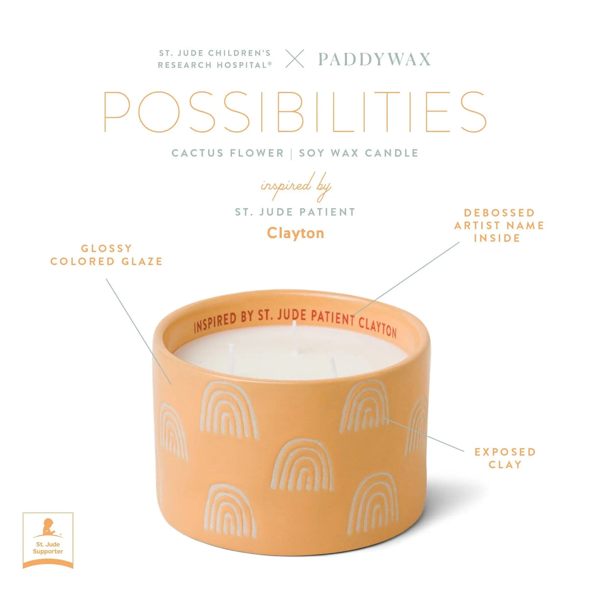 The Cactus Flower - St. Jude Giveback "Possibilities" 11 oz. Candle features a peach ceramic vessel, soy wax, white rainbow designs, and “Inspired by St. Jude patient Clayton” inside the rim. This Paddywax candle supports childhood cancer research.