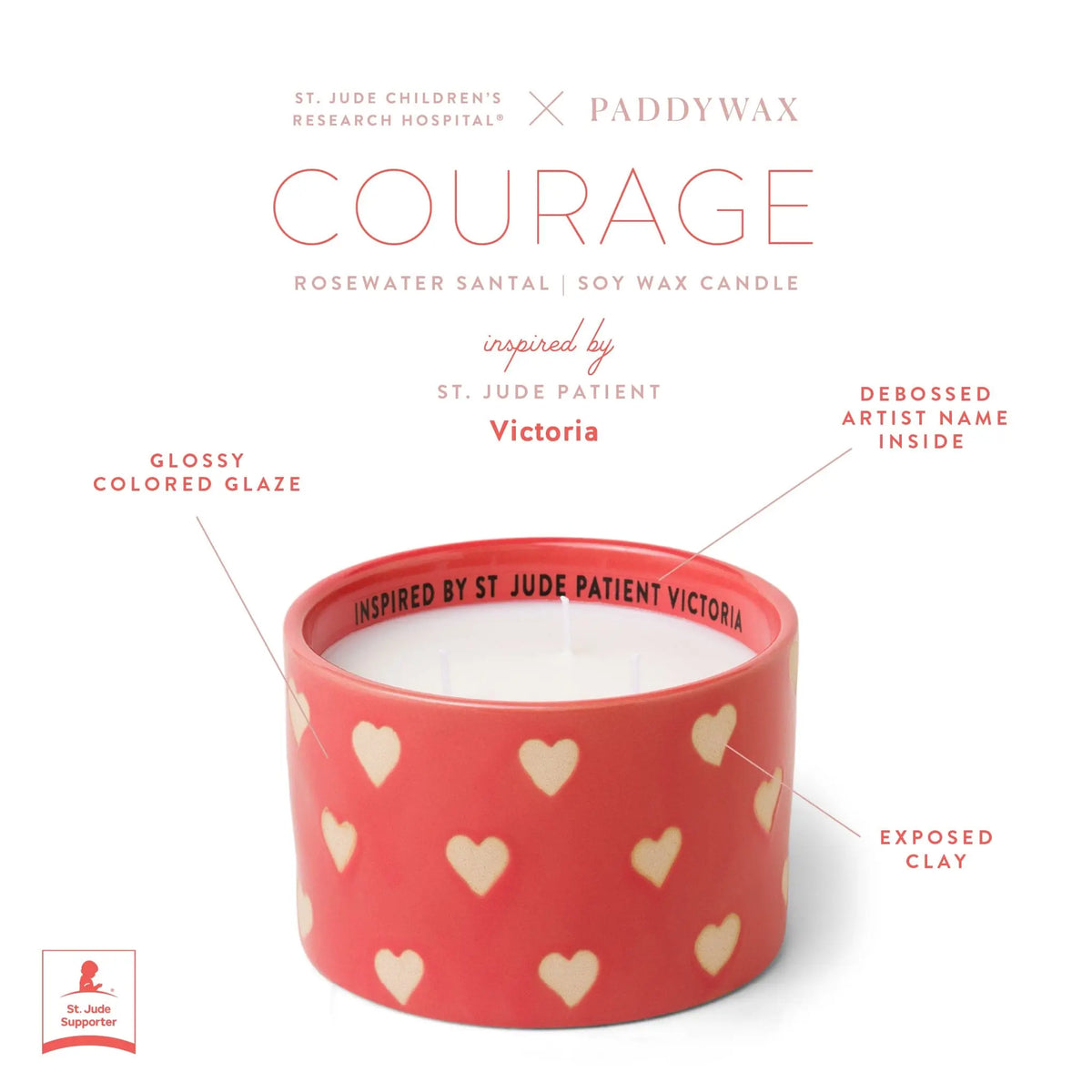 The Rosewater Santal - St. Jude Giveback "Courage" 11 oz. Candle features a pink ceramic vessel with white hearts, glossy glaze, exposed clay, debossed Victoria inside the rim, and is a St. Jude x Paddywax collaboration.