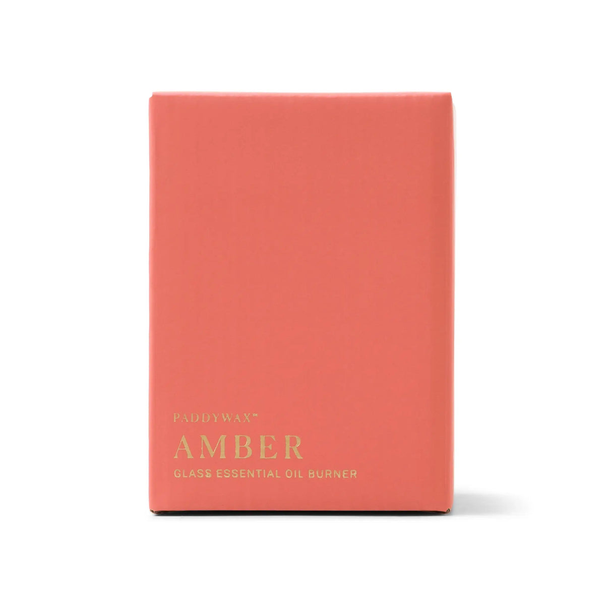 A coral-colored rectangular box with gold text displays "Amber Glass - Essential Oil Burner & Tea Light Candle" on the front. Designed for use with a tea light candle, this essential oil burner features sleek amber glass. The background is white.