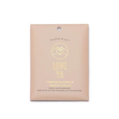 A beige packet of Tobacco + Vanilla "Love Ya" - Impressions Car Fragrance, featuring two scented plaques with notes of tobacco, vanilla, and sandalwood.